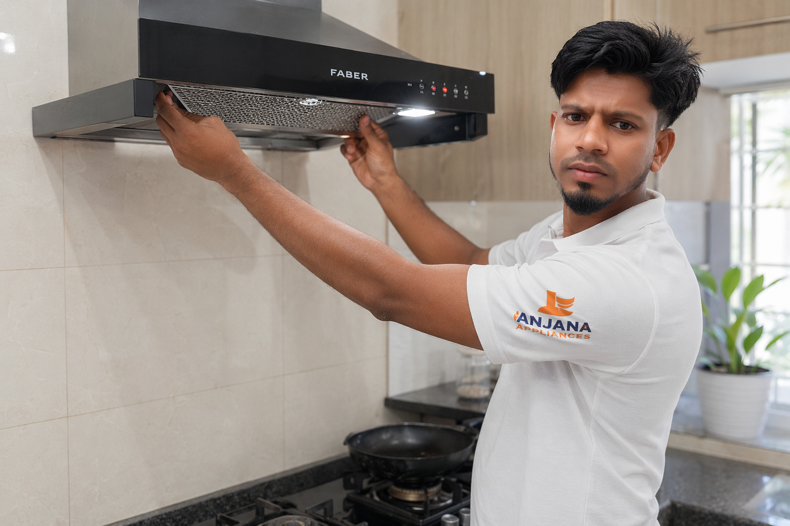 Our technician servicing a kitchen chimney